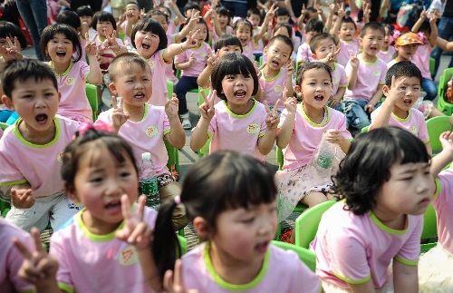 Children take part in a birthday party at the Luohan Temple in Shifang City, southwest China's Sichuan Province, May 12, 2013. The children were born at the Luohan Temple five years ago after the devastating earthquake jolted Wenchuan County of Sichuan on May 12, 2008. The temple then was used as a temporary obstetrics hospital from May 13 to Aug. 7 in 2008 to deliver newborn babies. A total of 108 babies were born at the temple until the local maternal and child health care hospital reopened. (Xinhua/Jiang Hongjing) 