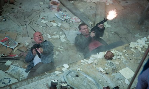 Always up for a little father-son bonding, Bruce Willis as John McClane and Jai Courtney as son Jack let 'er rip in the latest Die Hard flick. Photo: CFP