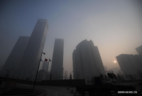 Buildings are shrouded in a dense smog near the CBD (Central Business District) area in Beijing, capital of China, Jan. 12, 2013. Beijing was shrouded in dense smog for a second straight day Saturday. The smoggy weather will not clear up until Monday, the city's environment monitoring center said. Beijing's air is heavily polluted. Readings for PM2.5, or airborne particles with a diameter of 2.5 microns or less -- small enough to deeply penetrate the lungs -- were as high as 456 on Saturday. (Xinhua/Luo Xiaoguang)