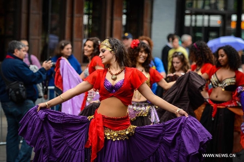 People participate in the annual Dance Parade in New York, on May 18, 2013. Over 200 dance groups showcasing 80 unique dance styles and cultures gathered from Broadway to the East Village on Saturday for the 7th Dance Parade in New York. (Xinhua/Niu Xiaolei) 