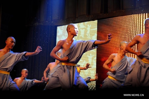 Performers of the Yandong Shaolin Kungfu troupe show their Kungfu during a performance held at the Worker's Cultural Palace, Taiyuan, capital of north China's Shanxi Province, July 6, 2013. The martial art troupe have their performers trained in the renowned Shaolin Temple, and staged performances worldwide in the hope of promoting Shaolin-style martial arts and Chinese culture. (Xinhua/Fan Minda)&nbsp; 