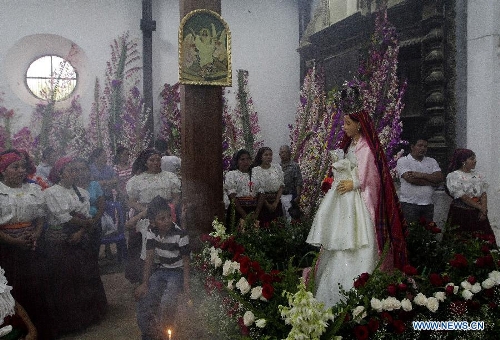 Residents participate in the procession of 