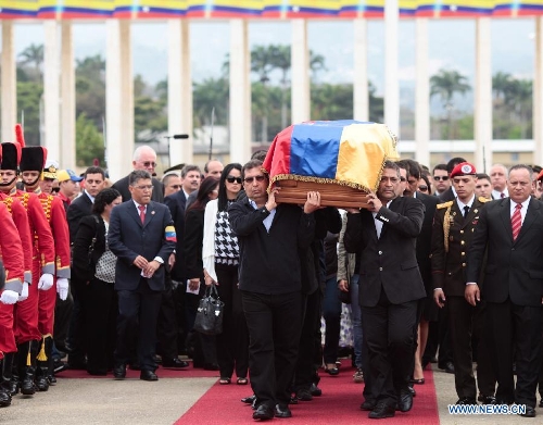 The body of late Venezuelan President Hugo Chavez is carried from the Military Academy to the Mountain Barracks, in the city of Caracas, capital of Venezuela, on March 15, 2013. Venezuelans honored late President Hugo Chavez, before his remains were transfered to the Mountain Barracks, where he will rest inside a glass case. Venezuelan President died on March 5, after struggling with cancer for two years. (Xinhua/AVN) 