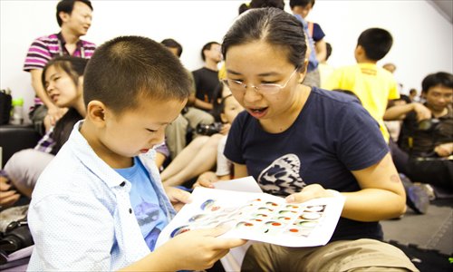 Kids participate in a Nature Fun workshop with their parents.