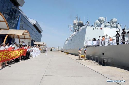 Chinese People's Liberation Army (PLA) Navy soldiers stand on board at the frigate 