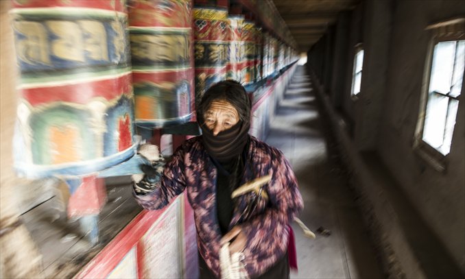 A woman rotates prayer wheels in Kirti Monastery in Aba, Sichuan Province on March 4. Photo: Li Hao/GT