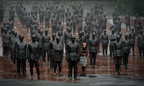 Visitors walk among statues at a War of Resistance against Japanese Aggression 
(1937-1945) memorial at the Jianchuan Museum in Chengdu, Sichuan Province. Photo: IC