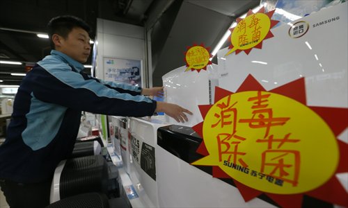 A salesman lays out disinfection appliances in an appliance superstore in Beijing Sunday. The sales volume of disinfection appliances rose by 50 percent in the first week of April compared with the previous week in Beijing due to concerns about the deadly H7N9 bird flu. Photo: CFP