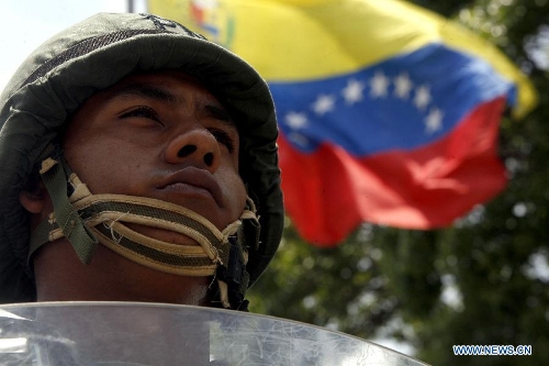 A soldier takes part in the Republic Plan, prior to the Venezuelan presidential elections, in Caracas, capital of Venezuela, on April 10, 2013. Venezuela will hold presidential elections on April 14. The Republic Plan is held to guarantee the security on the presidential electoral process. (Xinhua/AVN) 