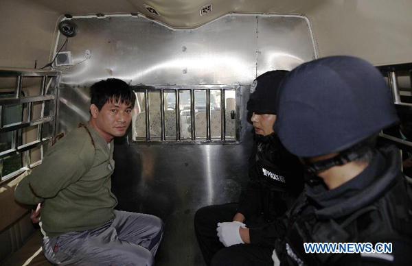 Myanmar drug lord Naw Kham (L) sits in a police van before being taken to the place of execution in Kunming, capital of southwest China's Yunnan Province, March 1, 2013. Naw Kham and three of his accomplices, identified as Hsang Kham, Yi Lai, and Zha Xika, were executed by lethal injection in Kunming on Friday afternoon, according to the Intermediate People's Court of Kunming. The four were convicted of murdering 13 Chinese sailors on the Mekong River in 2011. Photo: Xinhua