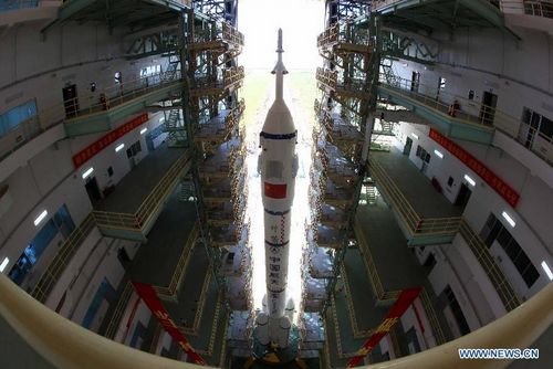 The Shenzhou-9 manned spacecraft, the Long March-2F rocket, and the escape tower wait to be vertically transferred to the launch pad at the Jiuquan Satellite Launch Center in northwest China's Gansu Province, June 9, 2012. China will launch its Shenzhou-9 manned spacecraft sometime in mid-June to perform the country's first manned space docking mission with the orbiting Tiangong-1 space lab module, a spokesperson with the country's manned space program said Saturday. Photo: Xinhua