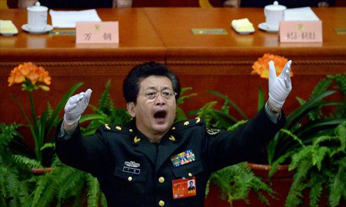 A Chinese People's Liberation Army (PLA) officer conducts delegates singing the national anthem at the closing session of the Chinese People's Political Consultative Conference (CPPCC) at the Great Hall of the People in Beijing on Wednesday. Photo: AFP