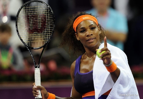 Serena Williams of the United States entertains the spectators after winning the women's semifinal against Maria Sharapova of Russia at the Qatar Open tennis tournament in Doha, capital of Qatar, Feb. 16, 2013. Serena Williams won 2-0. (Xinhua/Chen Shaojin) 