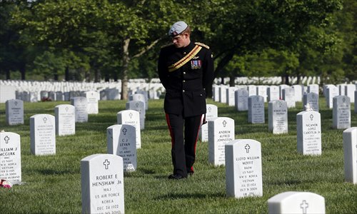 Prince Harry of Britain visits Arlington National Cemetery on Friday. The royal, a captain in the British Army who just returned from a tour of duty in Afghanistan, laid a wreath at the Tomb of the Unknown Solider. He is on a week-long tour of the US, where he is visiting charities. Photo: AFP