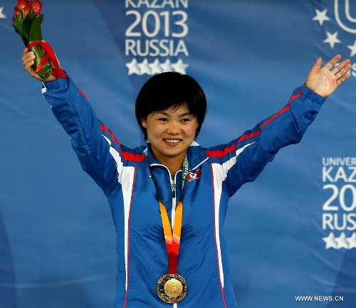 Gold medalist Pyon Yong Mi of the Democratic People's Republic of Korea (DPRK) celebrates victory during the awarding ceremony of women's 63kg weightlifting at the 27th Summer Universiade in Kazan, Russia, July 9, 2013. Pyon Yong Mi claimed the title with 233kg in total. (Xinhua/Li Ying) 