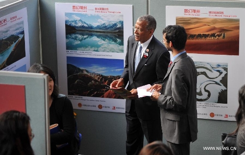  Visitors view pictures at a photo exhibition named 