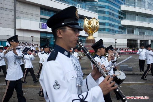 Musical band of Hong Kong police march before a flag-raising ceremony held to celebrate the 16th anniversary of Hong Kong's return to the motherland, in Hong Kong, south China, July 1, 2013. (Xinhua/Lui Siu Wai) 