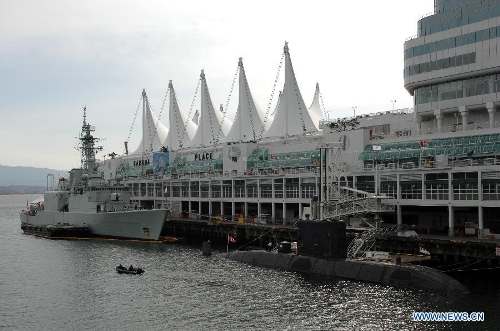 Royal Canadian Navy destroyer HMCS Algonquin (L) and long-range submarine HMCS Victoria are seen at bay during a media presentation in Vancouver, Canada, on April 26, 2013. Approximately 1,000 Canadian and American sailors are in Vancouver to meet members of the public and media to bring the Navy to the Canadians. (Xinhua/Sergei Bachlakov) 
