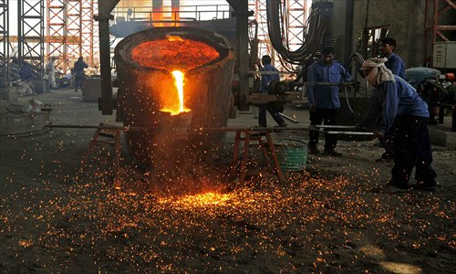Afghan laborers work at the Kabul Foulad Steel plant in Herat on Tuesday. Afghanistan is believed to have mineral reserves worth as much as $3 trillion, which could theoretically generate billions of dollars in tax revenue for the troubled country. Photo: AFP