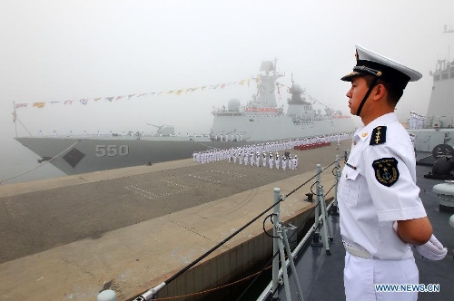 Chinese naval personnel take part in a ceremony for the departure of a fleet in the port of Qingdao, east China's Shandong Province, July 1, 2013. A Chinese fleet consisting of seven naval vessels departed from east China's harbor city of Qingdao on Monday to participate in Sino-Russian joint naval drills scheduled for July 5 to 12. The eight-day maneuvers will focus on joint maritime air defense, joint escorts and marine search and rescue operations. (Xinhua/Zha Chunming) 