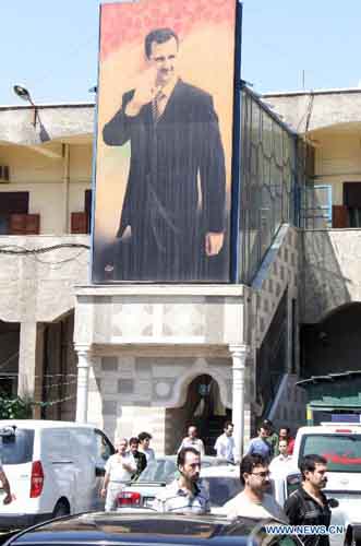 Prisoners are seen outside the headquarters of the Police Command in Damascus, Syria, September 9, 2012. Dozens of prisoners have been released from Syrian jails on Sunday as part of the government's reform program. Syria says those who were released didn't take part in bloody events in the country and their hands were clean from the Syrians' blood. Hundreds of prisoners were released over the past few weeks in different cities and provinces. Photo: Xinhua