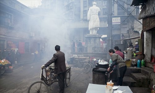 Smoke from incense and firecrackers set off by worshippers surround a Mao statue in Huangshi, Hubei Province, on December 26, 2007, Mao's 114's birth anniversary. Photo: Cheng Wenjun