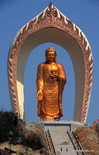 The Donglin Buddha statue is seen at the Donglin Temple in Xingzi County of Jiujiang City, east China's Jiangxi Province, March 6, 2013. The bronze statue of Amitabha Buddha, which is 48 meters in height, is believed to be the tallest of its kind in the world. The project, with the total cost of about 1 billion yuan (161 million U.S. dollars), has been basically completed. It was totally funded by private donations. (Xinhua/Song Zhenping)  