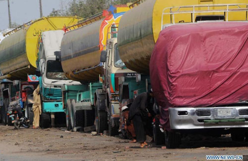 Oil tankers used to transport fuel to NATO forces in Afghanistan are seen at NATO supply terminal in southern Pakistani port city of Karachi, on July 3, 2012. Pakistan on Tuesday night announced that it is reopening land routes for NATO forces in neighboring Afghanistan after US Secretary of State, Hillary Clinton, apologized over the killing of 24 Pakistani soldiers in last November air strike, the country's Information Minister, Qamar-uz-Zaman Kaira said. Photo: Xinhua