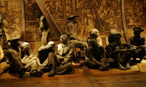 Statues of overworked migrants at the Overseas Chinese Museum Photo: CFP