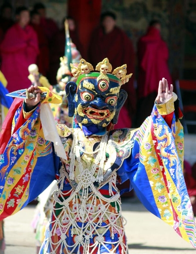 A masked Buddhist monk performs a ritual dance to pray for good fortune and harvest at the Labrang Monastery in Xiahe County, Gannan Tibetan Autonomous Prefecture, northwest China's Gansu Province, Feb. 23, 2013. The Labrang Monastery is among the six great monasteries of the Geluk school of Tibetan Buddhism. (Xinhua/Shi Youdong)  