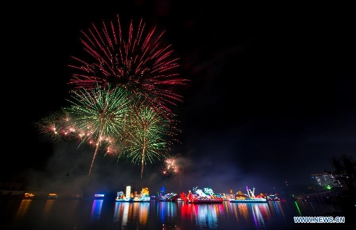 Fireworks explode at the end of the night parade activity in Putrajaya, Malaysia, June 30, 2013. A total of 14 floats attend a night parade activity here on Sunday.(Xinhua/Chong Voon Chung) 