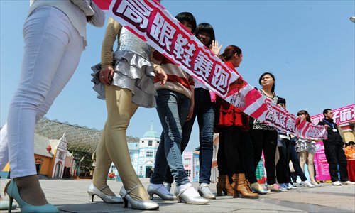 Runners wait at the starting line in a high-heel running competition held in the Window of the World Park in Changsha, Hunan Province on Wednesday to celebrate International Women's Day on Friday. Related festivities at the park will last until Sunday. Photo: CFP