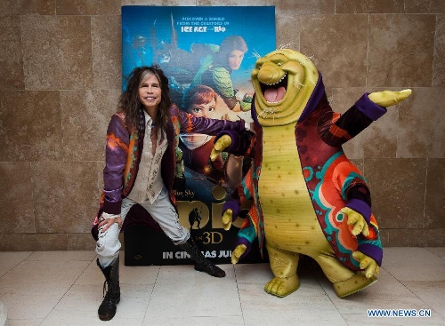 Aerosmith singer Steven Tyler poses for photos with a character of movie 