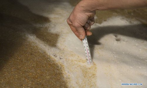 Jean Van Roy, head of the Cantillon brewery measures the temperature of liqour during the brewing process in Brussels, capital of Belgium on Nov. 10, 2012. Cantillon brewery, founded in 1900, is one of the few beer brewers still running in Brussels city. It follows traditional way to brew lambic style beers, a unique spontaneous fermented beer only produced in Brussels region. Photo: Xinhua