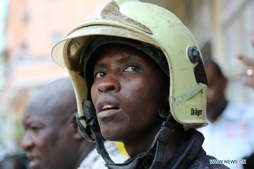 A rescuer is seen at the building collapse site in downtown Dar es Salaam, Tanzania, March 29, 2013. A 16-storey building on Friday morning collapsed in Dar es Salaam, with more than 60 people got trapped in the debris. No casualties have been reported as of noon local time. (Xinhua/Zhang Ping)