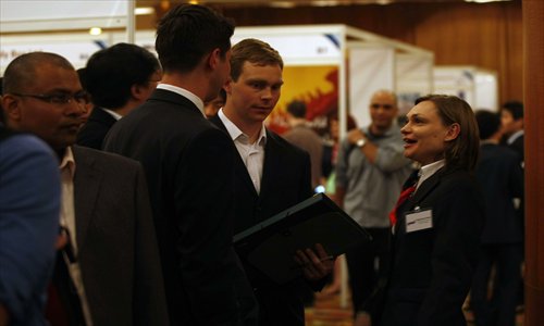 Some foreigners are willing to take work at low wages to help develop their career. Photo:  CFP