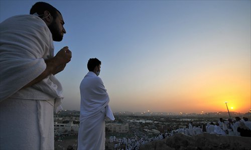 Muslim pilgrims pray on Mount Arafat, near the holy city of Mecca, one day ahead of the haj main ritual, on Sunday. Vast crowds of Muslim pilgrims, all dressed in white, flock from early morning to Mount Arafat, in western Saudi Arabia, to take part in the main rituals of the annual haj. Photo: AFP