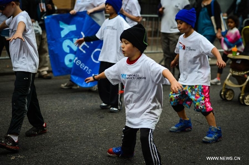 People participate in the annual Dance Parade in New York, on May 18, 2013. Over 200 dance groups showcasing 80 unique dance styles and cultures gathered from Broadway to the East Village on Saturday for the 7th Dance Parade in New York. (Xinhua/Niu Xiaolei) 