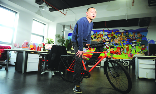 Cui Mengmeng, 30 and working in advertising, shows off his 2011 Vintage Series bike from historic Chinese bicycle brand Forever.