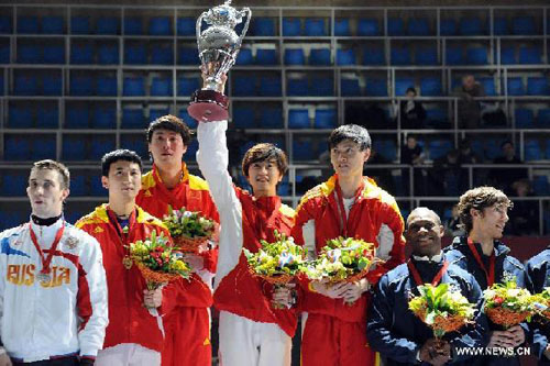Zhong Man (3rd R) of China's men's sabre team celebrates with teammates during the award ceremony for the men's sabre team at FIE Moscow Tournament in Moscow, capital of Russia, March 18, 2012. China defeated Russia 45-44 to claim the title. Photo: Xinhua