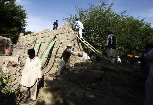 Afghan men search among debris of a house destroyed by an earthquake in east Afghanistan's Nangarhar province, on April 24, 2013. A tremor jolted Afghan capital Kabul and its eastern provinces at 01: 55 p.m. local time on Wednesday, claiming the lives of three people and injuring 70 others, an official said. (Xinhua/Tahir Safi)