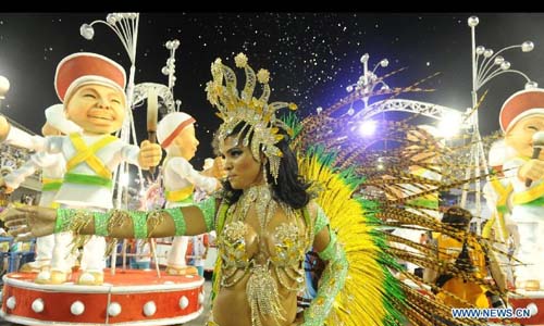 A reveler participates in the annual carnival samba parade in Rio de Janeiro, Brazil, Feb. 10, 2013. The 2013 Rio carnival samba parade began on Sunday. Photo: Xinhua