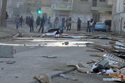 Bahraini protesters clash with police forces following the funeral of a teenager killed in protests marking the second anniversary of the 2011 mass anti-government demonstrations, in the village of Jabalat Habshi, west of Manama, Bahrain, Feb. 16, 2013. Two people were killed and 75 police officers injured in Bahrain since violent clashes erupted on the eve of the second anniversary of the 2011 mass anti-government demonstrations, Interior Minister Lieutenant General Shaikh Rashid bin Abdullah Al Khalifa said Saturday. (Xinhua/Ali Mahmood)
