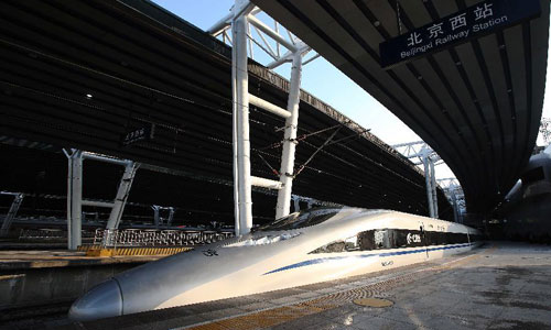 The G83 express train pulls out of Beijing West Station during a trial trip for journalists from Beijing, capital of China, December 22, 2012. China is set to open the world's longest high-speed railway on December  26, linking Beijing and the southern economic center of Guangzhou. Running at an average speed of 300 km per hour, the 2,298-km Beijing-Guangzhou high-speed railway will cut travel time between the two cities to about 8 hours. Designed with a maximum speed of 350 km per hour, the railway has 35 stops in major cities, including Shijiazhuang, capital of north China's Hebei Province, Zhengzhou, capital of central China's Henan Province, Wuhan, capital of central China's Hubei Province and Changsha, capital of central China's Hunan Province. Photo: Xinhua 