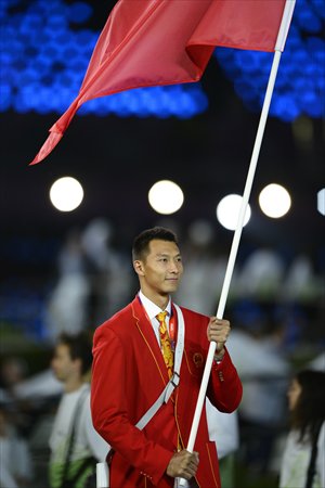 Yi Jianlian, basketball player, carries the flag for China during the opening ceremony of 2012 London Olympic Games. Photo: AFP