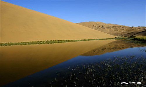 Photo taken on June 19, 2012 shows scenery of the Badain Jaran Desert in Alashan of north China's Inner Mongolia Autonomous Region. The Badian Jaran Desert is 47,000 square km and sparsely populated. It is famous for having the tallest stationary sand dunes in the world. Some dunes reach a height of 500 meters. But it also features spring-fed lakes that lie between the dunes. Photo: Xinhua
