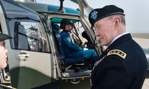 A translator introduces Dempsey to helicopter pilots during his tour of the airbase.