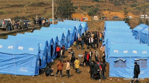 Photo taken on Jan. 12, 2013 shows tents installed for landslide-affected villagers at Gaopo Village in Zhenxiong County, southwest China's Yunnan Province. Landslide-affected villagers in Gaopo Village have been temporarily settled in tents and got life necessities. Forty-six people were killed in the Friday landslide. Another two people were injured. (Xinhua/Chen Haining) 