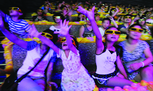 Visitors watch a 4D film played in a cartoon theme park in Hangzhou, capital city of East China's Zhejiang Province Tuesday. The park has attracted more than 500 million yuan ($79.3 million) investment by Hangzhou-based Worldland Group. China's theme park industry is expected to reach an annual market value of 10 billion yuan in the coming five years, market watchers said.  Photo: CFP