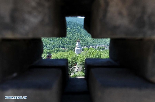 Photo taken on June 26, 2013 shows the white pagoda of the Tayuan Temple on Mount Wutai, one of four sacred Buddhist mountains in China, in north China's Shanxi Province. Added to UNESCO's World Heritage List in 2009, Mount Wutai is home to about 50 Buddhist temples built between the 1st century AD and the early 20th century. (Xinhua/Zhan Yan) 